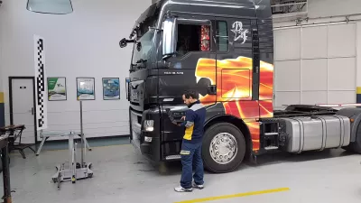 A person calibrating a truck
